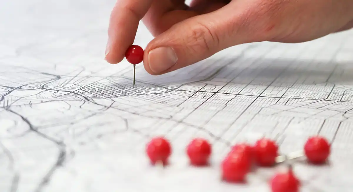 Image of a person placing location pin on a map